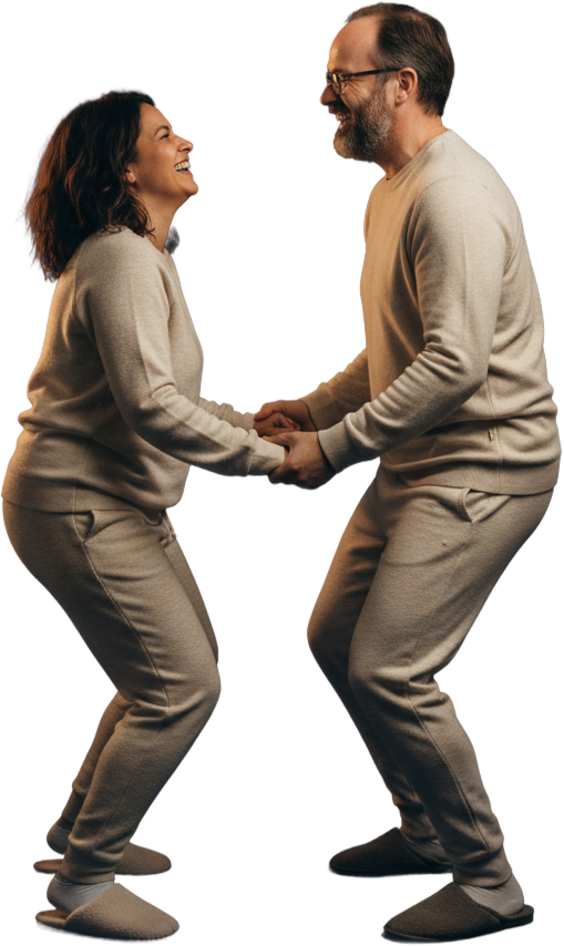 A couple dancing together in their loungewear, laughing, both Dumbo Health members